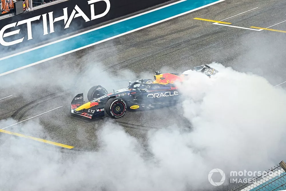 World Champion Max Verstappen, Red Bull Racing RB18, 1st position, performs donuts on the grid in celebration