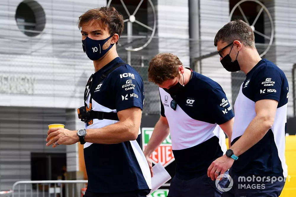 Pierre Gasly, AlphaTauri, walks the track with team mates