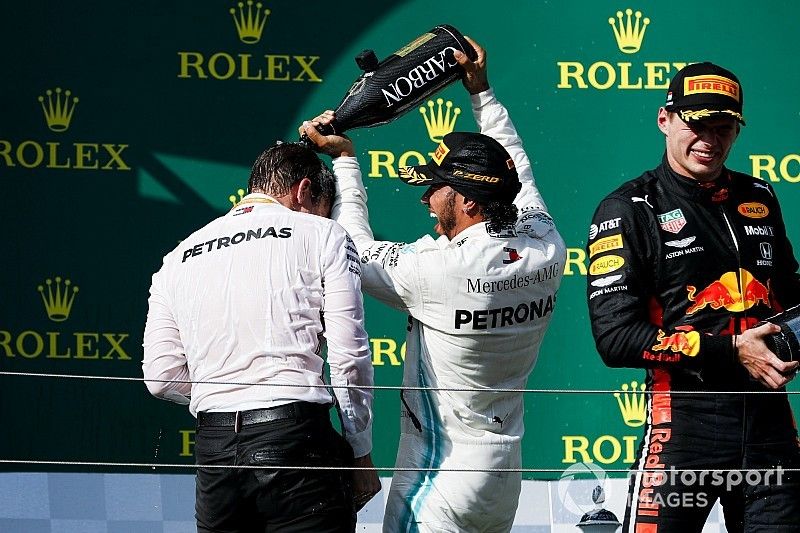 James Vowles, Motorsport Strategy Director, Mercedes AMG F1 and Race winner Lewis Hamilton, Mercedes AMG F1 celebrate on the podium with the champagne and Max Verstappen, Red Bull Racing