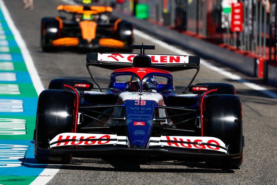 Daniel Ricciardo, RB F1 Team VCARB 01, Lando Norris, McLaren MCL38, out of the pit lane