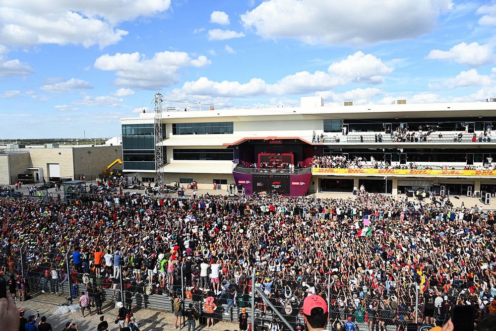 Fans fill the circuit after the race for the podium ceremony