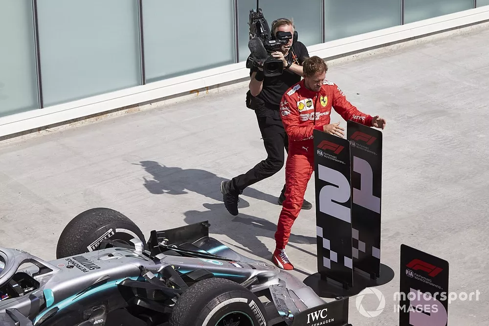 Sebastian Vettel, Ferrari, 2nd position, switches the position boards in protest of a penalty that cost him victory