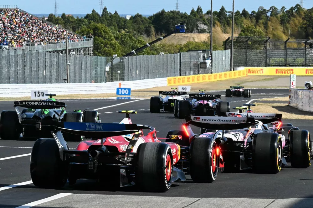 Cars leave the pit lane 
