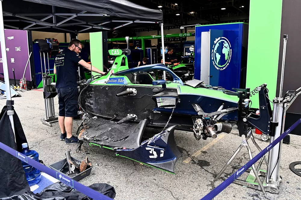 A mechanic works on the damaged car of Nick Cassidy, Envision Racing, Audi e-tron FE07
