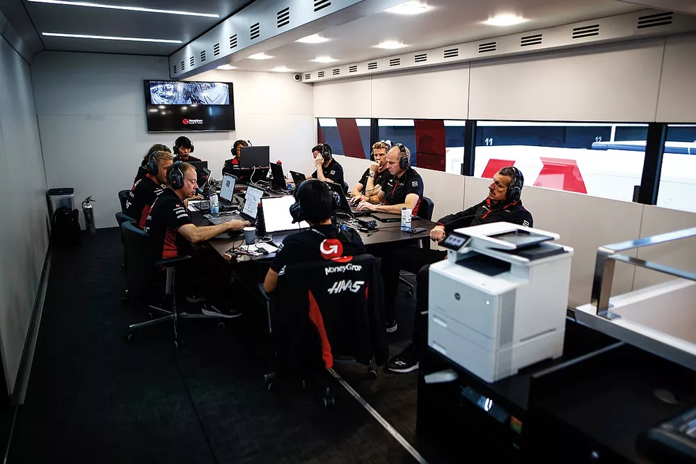 Guenther Steiner, Haas F1 team principal, Kevin Magnussen, Haas F1 Team, Nico Hulkenberg, Haas F1 Team and other team members at work