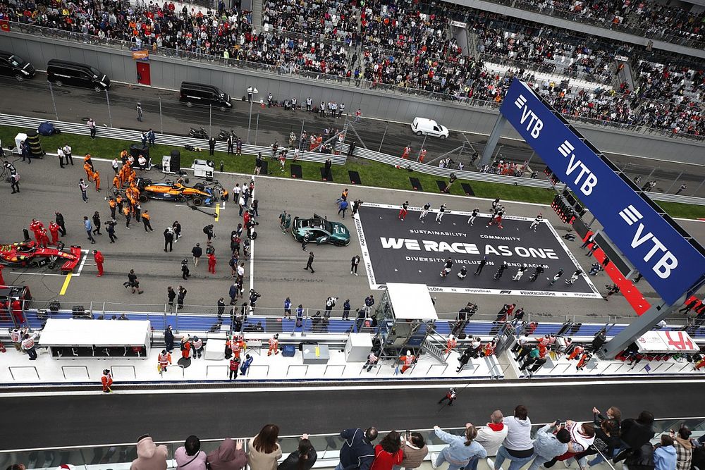 The drivers stand on the grid in support of the End Racism campaign prior to the start