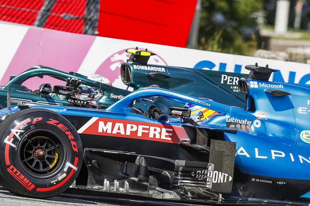 Fernando Alonso, Alpine A521, alongside Sebastian Vettel, Aston Martin AMR21