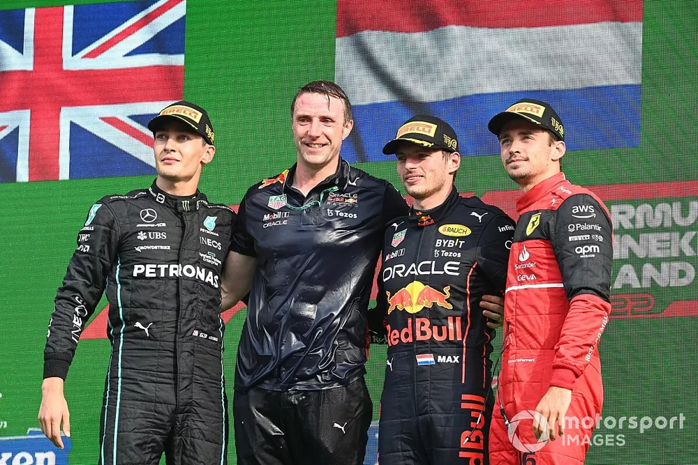 George Russell, Mercedes-AMG, 2nd position, the Red Bull trophy delegate, Max Verstappen, Red Bull Racing, 1st position, Charles Leclerc, Ferrari, 3rd position, on the podium
