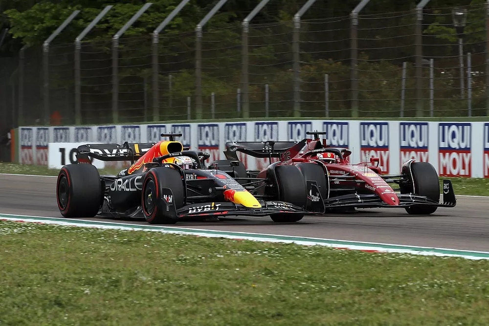 Max Verstappen, Red Bull Racing RB18, passes Charles Leclerc, Ferrari F1-75, for the lead