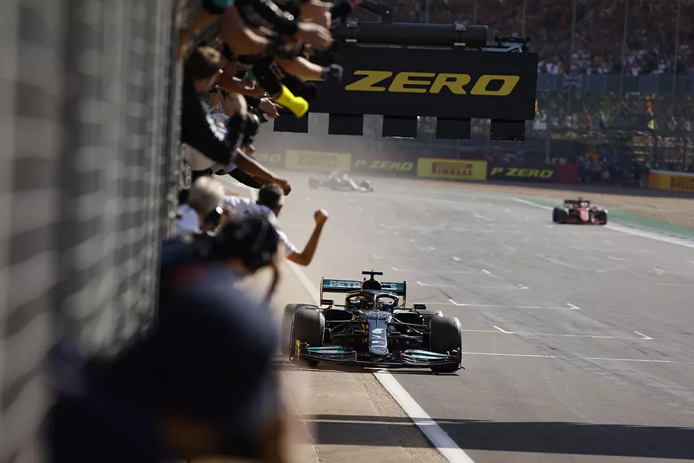 Lewis Hamilton, Mercedes W12, 1st position, passes his cheering team on the pit wall as he takes victory