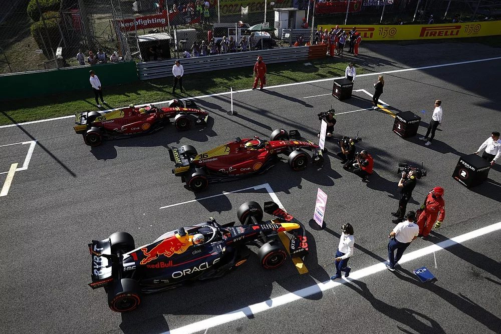 Max Verstappen, Red Bull Racing RB18, pole man Charles Leclerc, Ferrari F1-75, Carlos Sainz, Ferrari F1-75, on the grid at the end of Qualifying