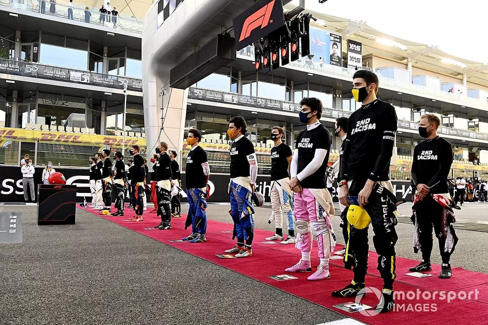 The drivers stand for the national anthem prior to the start