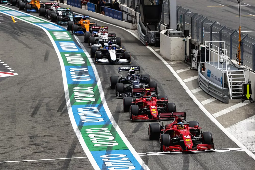 Charles Leclerc, Ferrari SF21, Carlos Sainz Jr., Ferrari SF21, and Pierre Gasly, AlphaTauri AT02, head the queue to leave the pits after the red flag in Q1