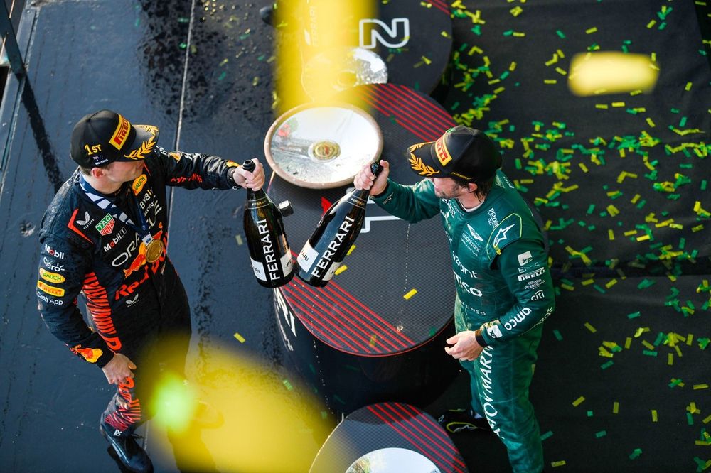 Max Verstappen, Red Bull Racing, 1st position, Fernando Alonso, Aston Martin F1 Team, 3rd position, celebrate with Champagne on the podium