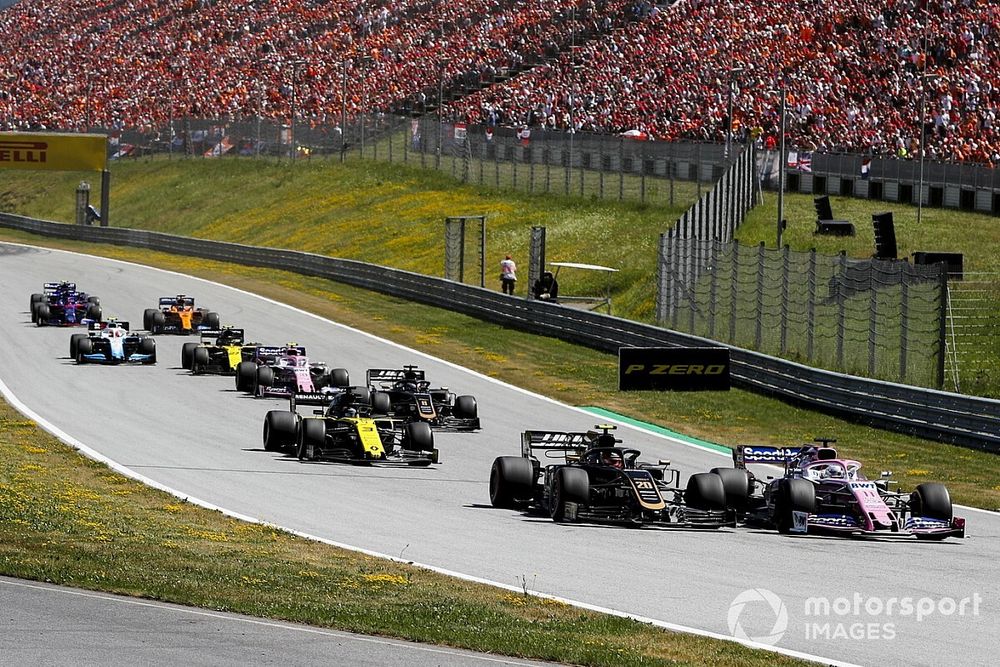 Sergio Perez, Racing Point RP19, leads Kevin Magnussen, Haas F1 Team VF-19, Daniel Ricciardo, Renault F1 Team R.S.19, Romain Grosjean, Haas F1 Team VF-19, Lance Stroll, Racing Point RP19, and the remainder of the field at the start