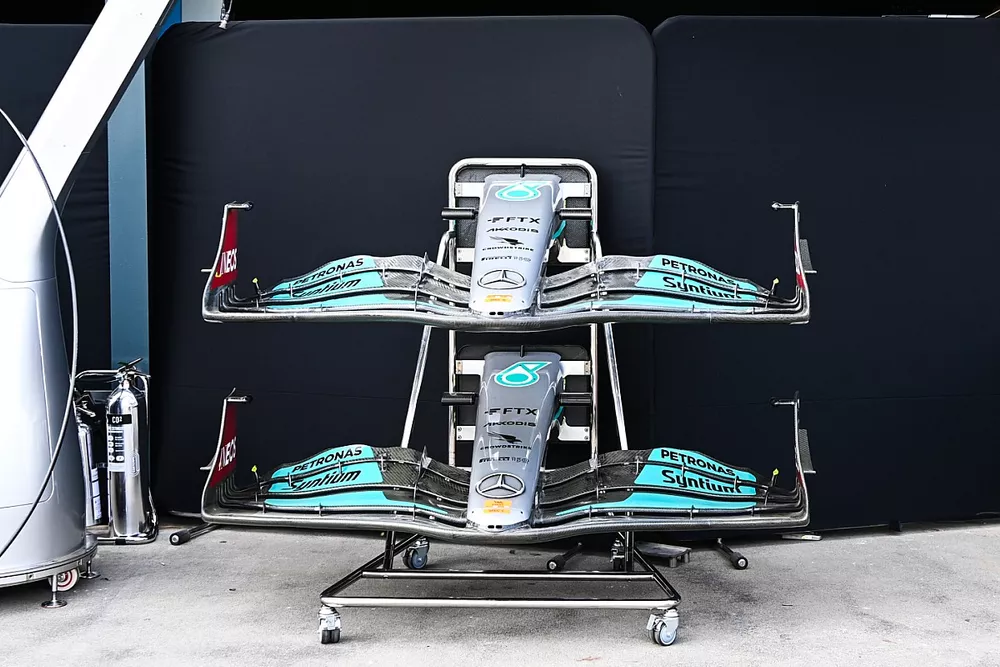 Mercedes W13 nose sections and front wings in the pit lane