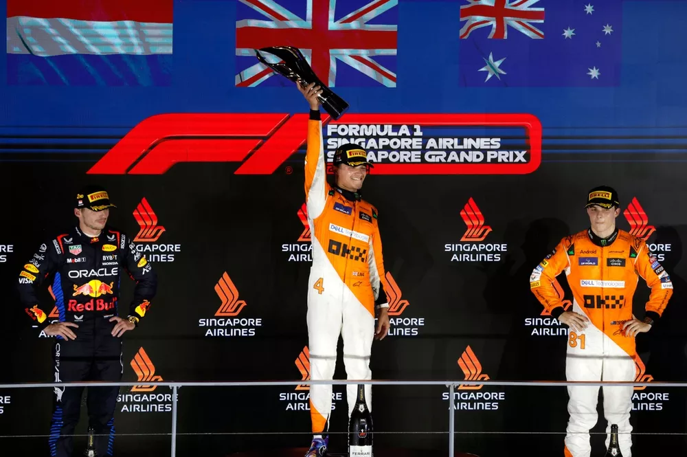 Max Verstappen, Red Bull Racing, 2nd position, Lando Norris, McLaren F1 Team, 1st position, and Oscar Piastri, McLaren F1 Team, 3rd position, on the podium