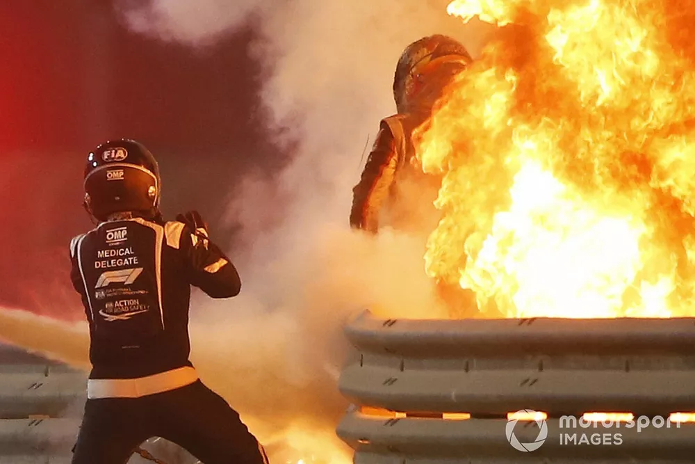 Romain Grosjean, Haas F1, emerges from flames after a horrific accident on the opening lap of the Bahrain Grand Prix. Marshals extinguish the fire