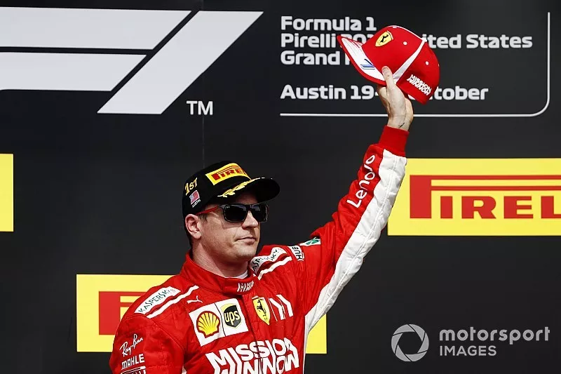 Kimi Raikkonen, Ferrari, celebrates on the podium after winning the race