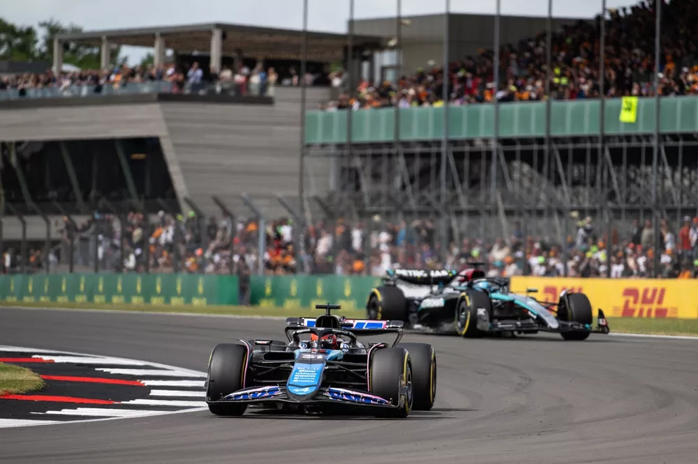 Esteban Ocon, Alpine A524, leads George Russell, Mercedes F1 W15
