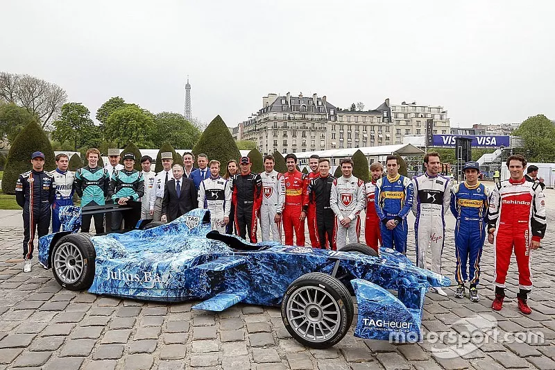 Drivers pose with the iceberg livery on a Formula E car that will be auctioned off to raise money to fight climate change