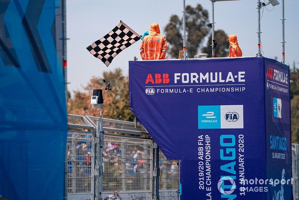 A marshal waves the chequered flag