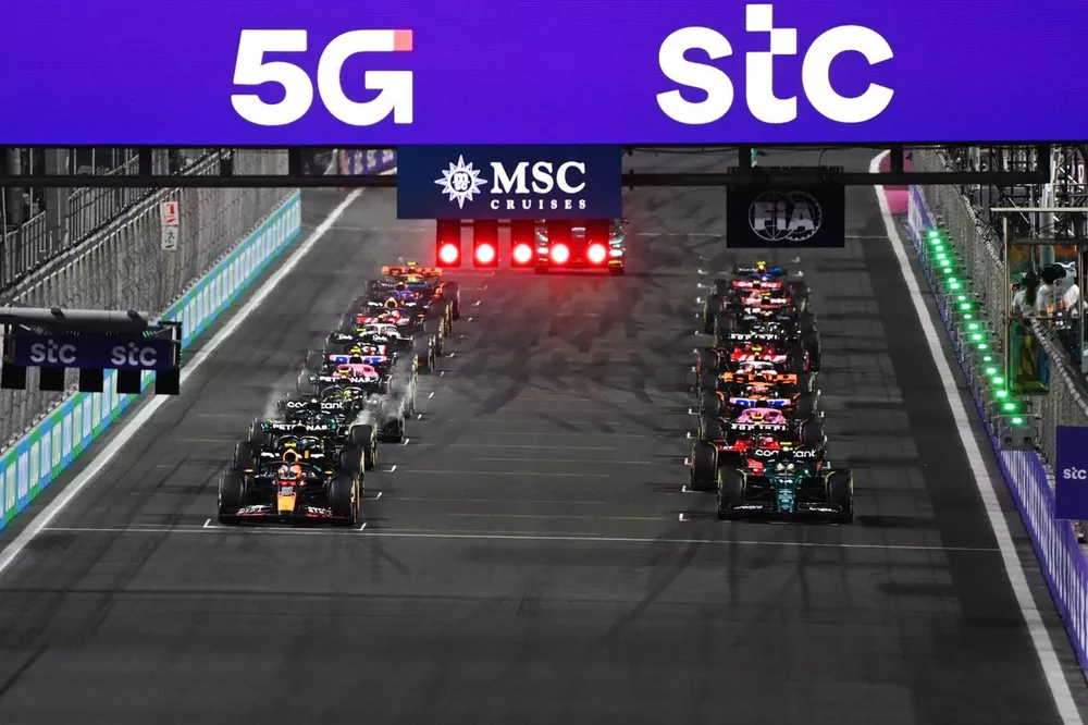 Sergio Perez, Red Bull Racing RB19, Fernando Alonso, Aston Martin AMR23, prepare to lead the field away at the start