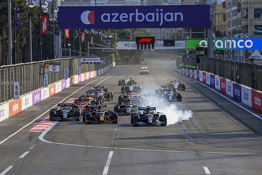 Lewis Hamilton, Mercedes W12 runs wide from Sergio Perez, Red Bull Racing RB16B at the restart of the race