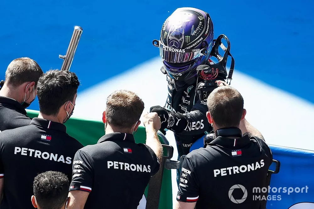Lewis Hamilton, Mercedes, celebrates in Parc Ferme with his team after securing a record 100th pole in F1