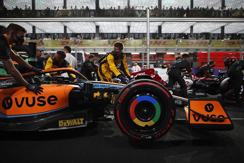 Mechanics push Lando Norris, McLaren MCL36