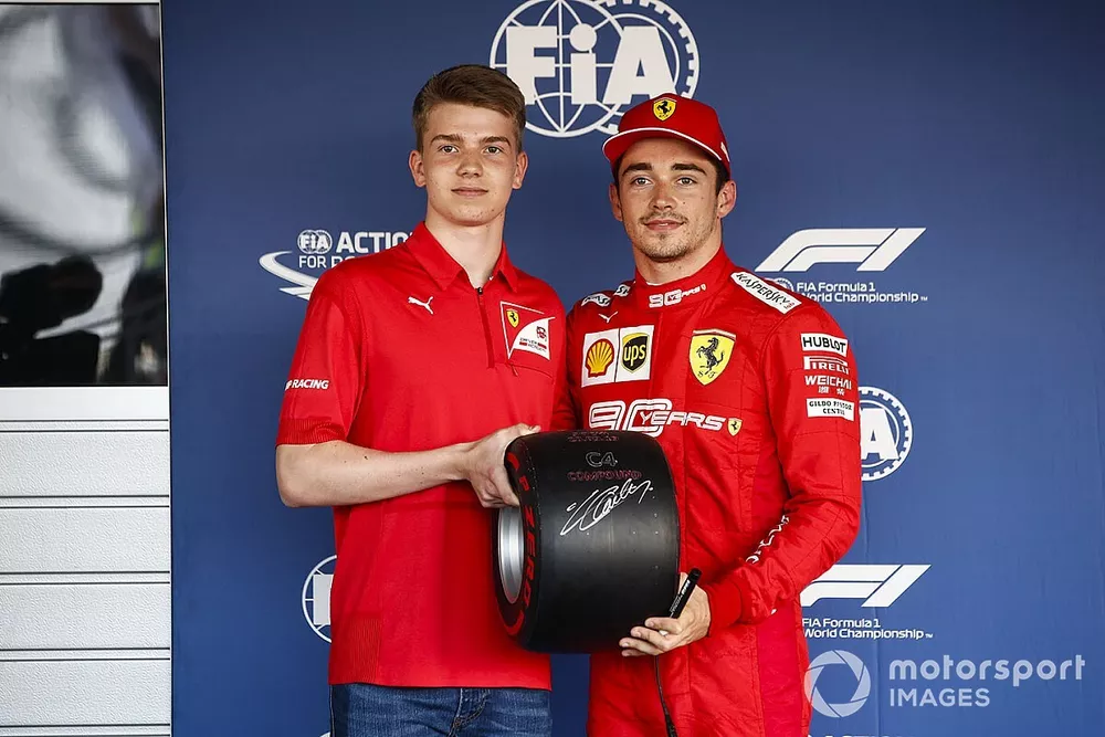 Charles Leclerc, Ferrari, celebrates pole position, and receives his Pirelli pole trophy from Robert Shwartzman, PREMA Racing 