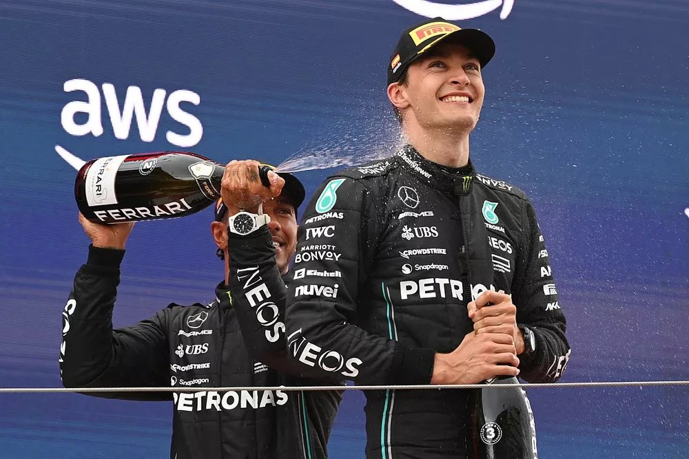 Lewis Hamilton, Mercedes-AMG, 2nd position, sprays George Russell, Mercedes-AMG, 3rd position, with Champagne on the podium