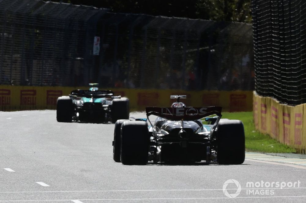 Fernando Alonso, Aston Martin AMR24, leads George Russell, Mercedes F1 W15