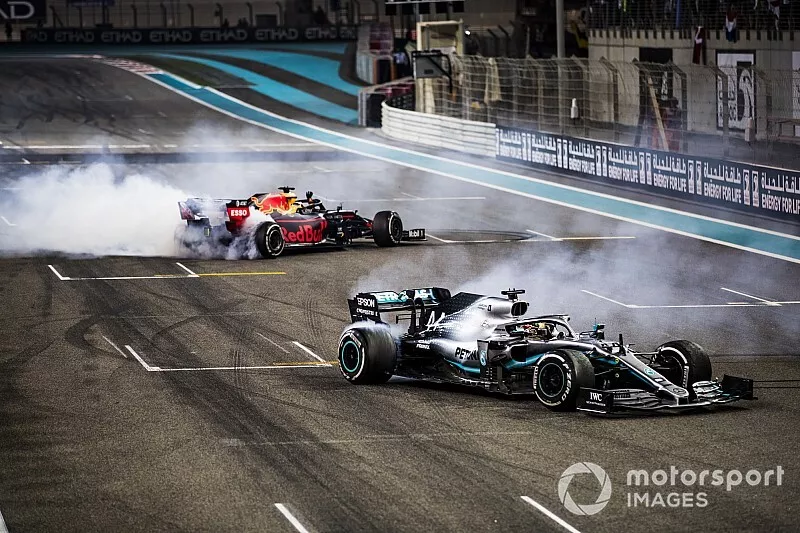 Max Verstappen, Red Bull Racing RB15, 2nd position, and Lewis Hamilton, Mercedes AMG F1 W10, 1st position, perform donuts