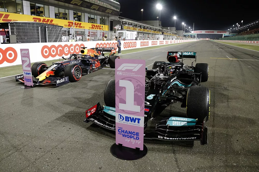 Lewis Hamilton, Mercedes W12, 1st position, and Max Verstappen, Red Bull Racing RB16B, 2nd position, arrive in Parc Ferme
