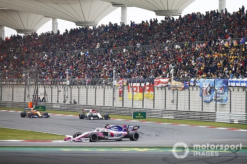 Sergio Perez, Racing Point RP19, leads Kimi Raikkonen, Alfa Romeo Racing C38, and Lando Norris, McLaren MCL34
