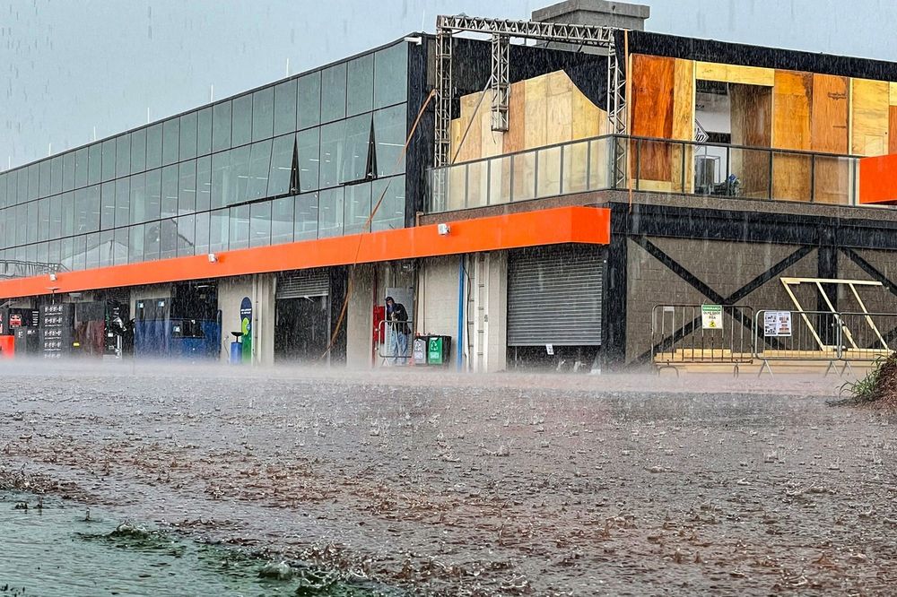 A heavy downpour floods the paddock