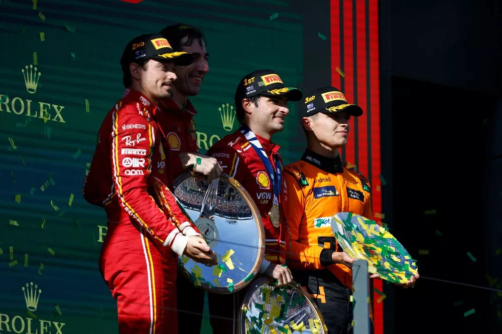 Charles Leclerc, Scuderia Ferrari, 2nd position, the Ferrari trophy delegate, Carlos Sainz, Scuderia Ferrari, 1st position, Lando Norris, McLaren F1 Team, 3rd position, on the podium with the trophies