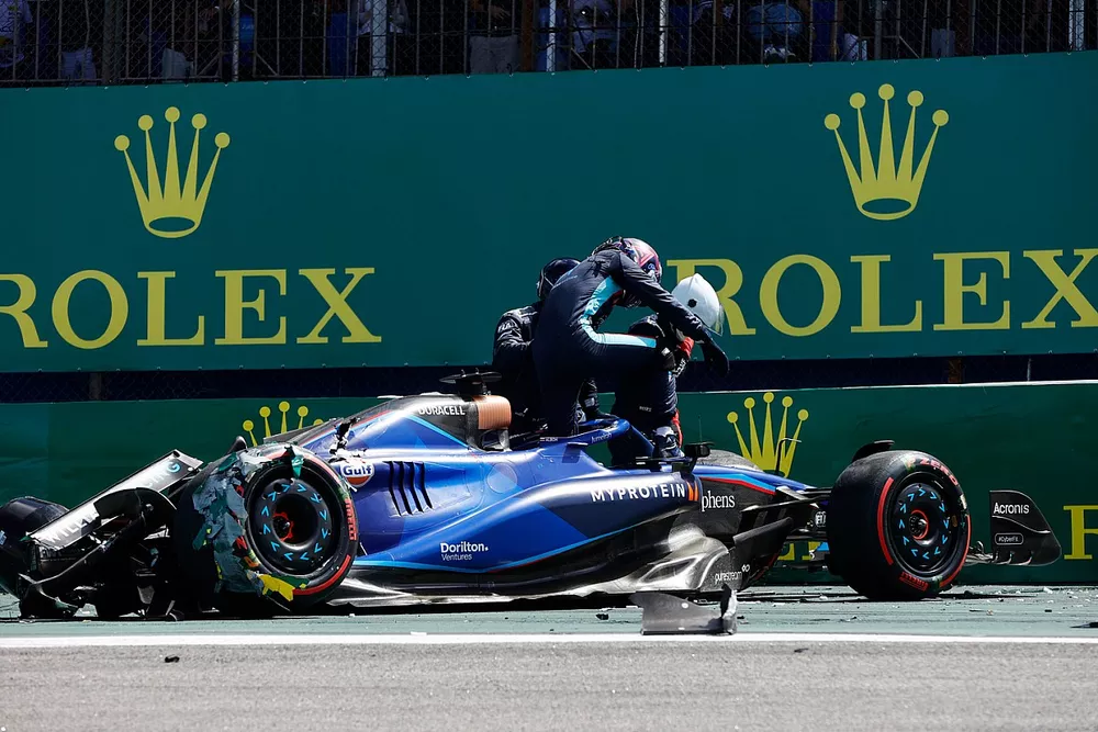 Alex Albon, Williams FW45, gets out of the car after crashing with Kevin Magnussen, Haas VF-23 