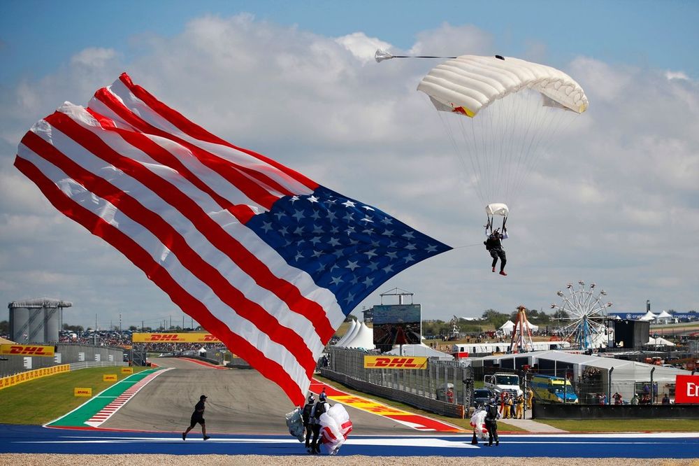 A parachutist arrives with a US flag