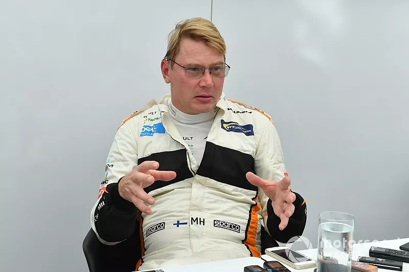 Mika Hakkinen talks with the media at Legends F1 30th Anniversary Lap Demonstration
