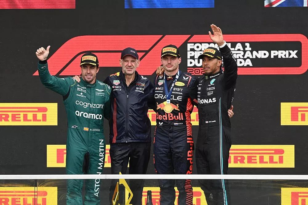 Fernando Alonso, Aston Martin F1 Team, 2nd position, Adrian Newey, Chief Technology Officer, Red Bull Racing, Max Verstappen, Red Bull Racing, 1st position, Lewis Hamilton, Mercedes-AMG, 3rd position, on the podium