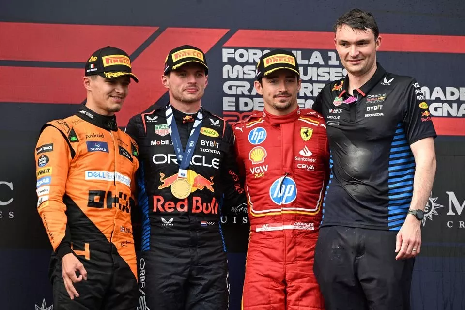 Lando Norris, McLaren F1 Team, 2nd position, Max Verstappen, Red Bull Racing, 1st position, Charles Leclerc, Scuderia Ferrari, 3rd position, stand on the podium for the Podium ceremony