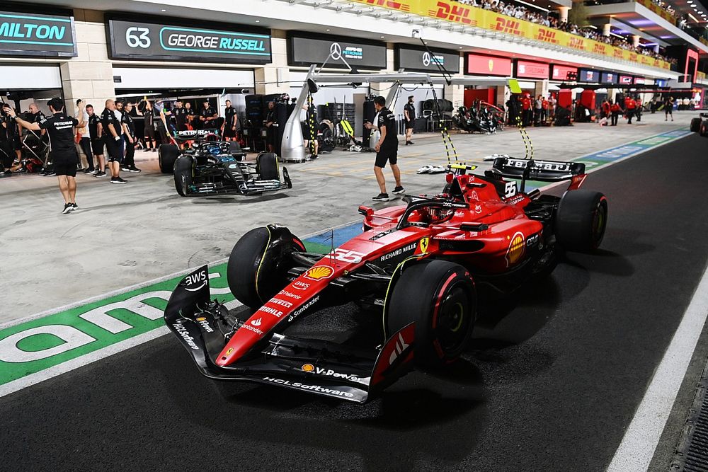 Carlos Sainz, Ferrari SF-23, George Russell, Mercedes F1 W14, in the pit lane