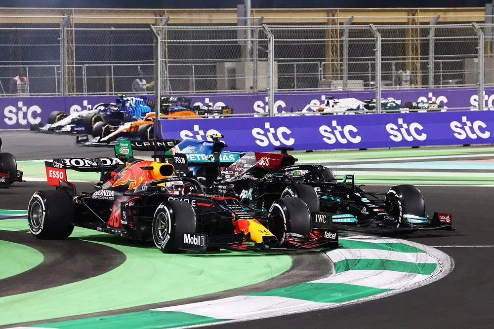 Max Verstappen, Red Bull Racing RB16B, and Lewis Hamilton, Mercedes W12, do battle at the restart