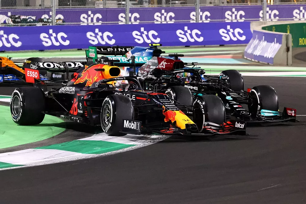Max Verstappen, Red Bull Racing RB16B, and Lewis Hamilton, Mercedes W12, do battle at the restart