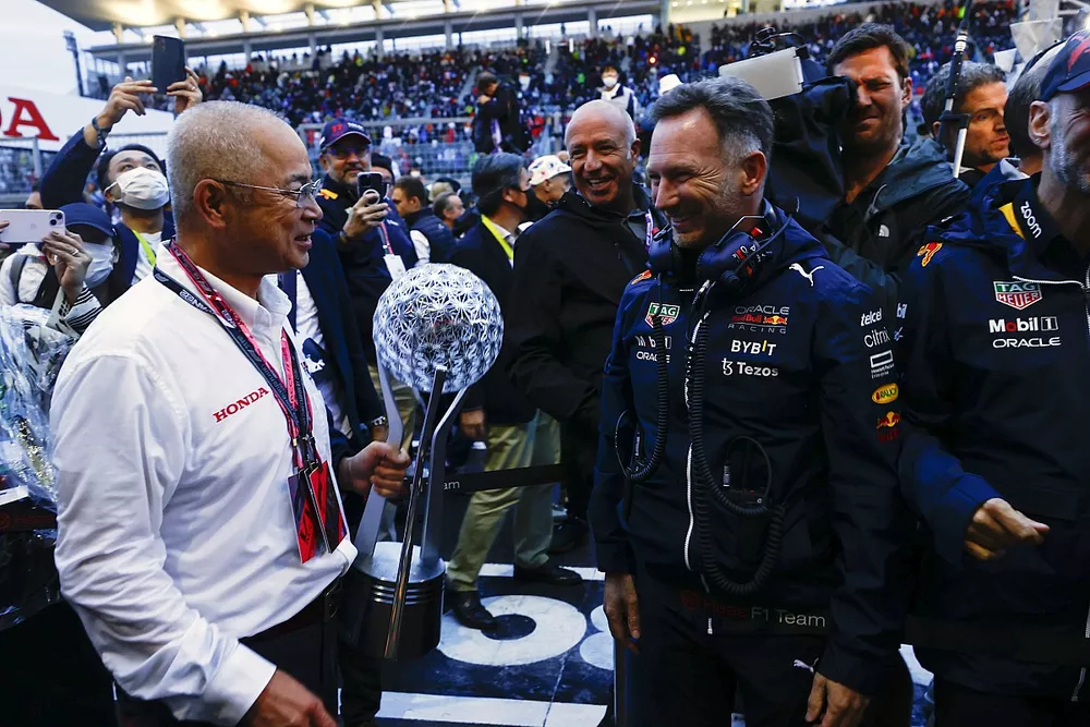 Christian Horner, Team Principal, Red Bull Racing, with the Honda Constructors trophy delegate in Parc Ferme