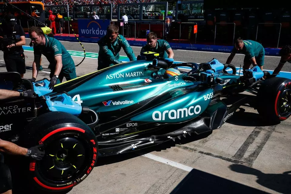 Fernando Alonso, Aston Martin AMR24, is returned to the garage