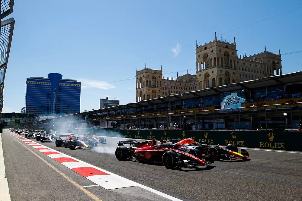 Sergio Perez, Red Bull Racing RB18, overtakes Charles Leclerc, Ferrari F1-75 for the lead at the start. Max Verstappen, Red Bull Racing RB18 and Carlos Sainz, Ferrari F1-75 follow