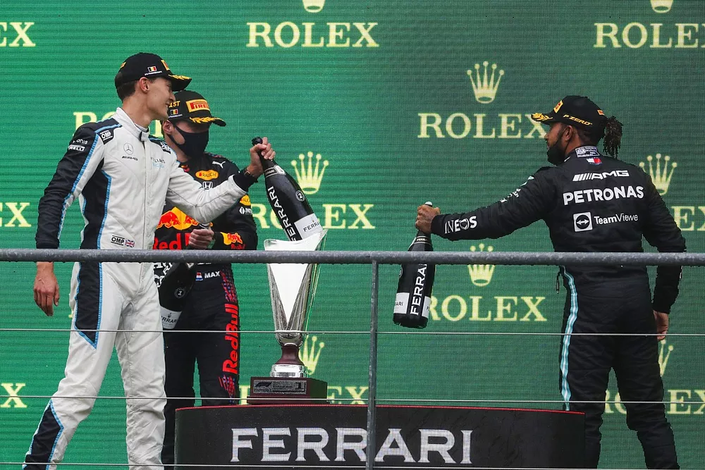 George Russell, Williams, 2nd position, Max Verstappen, Red Bull Racing, 1st position, and Lewis Hamilton, Mercedes, 3rd position, celebrate on the podium